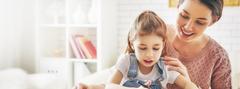 Girl coloring with her Mom