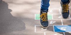 Child plays hopscotch.