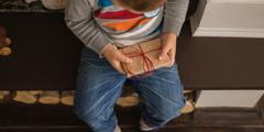 Child holds a gift in his hand.